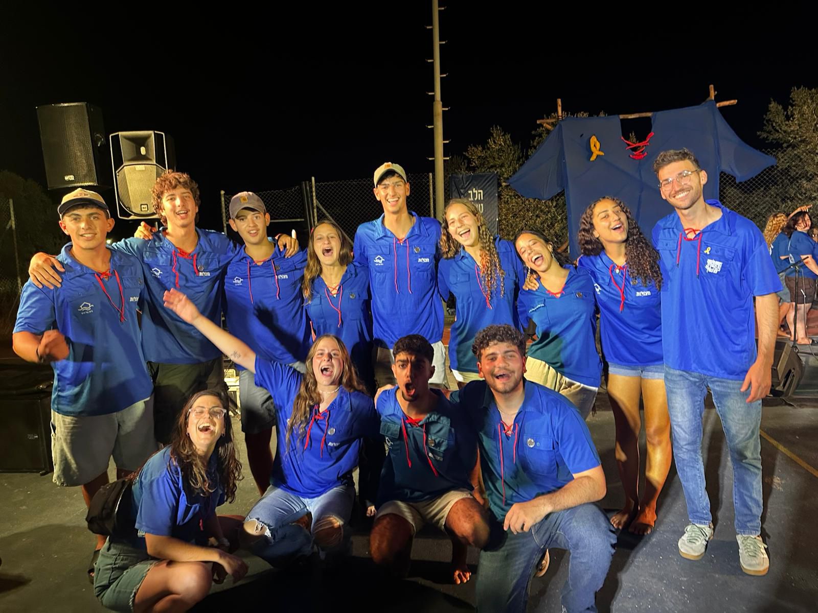 נערים ונערות עם חולצות כחולות של הנוער העבוד והלומד